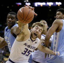 North Carolina's Joel James, left, and Kansas State's Austin Budke (35) chase a loose ball during the first half of an NCAA college basketball game Tuesday, Nov. 24, 2015, in Kansas City, Mo. (AP Photo/Charlie Riedel)