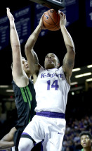 Kansas State's Justin Edwards (14) gets past North Dakota's Carson Shanks to put up a shot during the first half of an NCAA college basketball game Tuesday, Dec. 22, 2015, in Manhattan, Kan. (AP Photo/Charlie Riedel)
