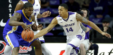 Kansas State's Justin Edwards (14) steals the ball from Coppin State's Blake Simpson during the first half of an NCAA college basketball game, Wednesday, Dec. 9, 2015, in Manhattan, Kan. (AP Photo/Charlie Riedel)