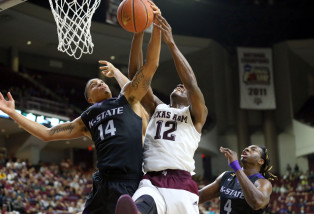 In this photo provided by Sam Craft, Kansas State's Justin Edwards (14) fights for a rebound against Texas A&M's Jalen Jones (12) during an NCAA college basketball game on Saturday, Dec. 12, 2015, in College Station Texas. (Sam Craft via AP)