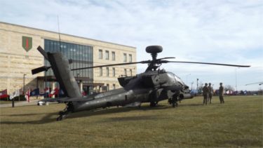 An Apache helicopter is displayed for local leaders and media in front of the 1st Infantry Division Headquarters Friday at Fort Riley. 