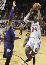 Oklahoma guard Buddy Hield (24) shoots as Kansas State forward Stephen Hurt left, defends, in the first half of an NCAA college basketball game in Norman, Okla., Saturday, Jan. 9, 2016. Oklahoma won 86-76. (AP Photo/Sue Ogrocki)