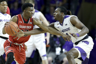 Kansas State's D.J. Johnson, right, attempts to steal the ball from Texas Tech's Keenan Evans during the second half of an NCAA college basketball game Tuesday, Jan. 12, 2016, in Manhattan, Kan. Kansas State won 83-70. (AP Photo/Charlie Riedel)