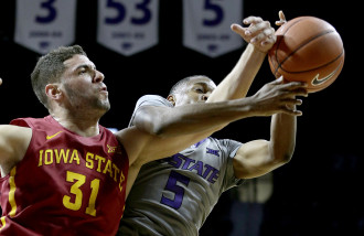 Iowa State's Georges Niang (31) and Kansas State's Barry Brown (5) chase the ball during the first half of an NCAA college basketball game Saturday, Jan. 16, 2016, in Manhattan, Kan. (AP Photo/Charlie Riedel)
