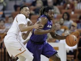 Kansas State forward D.J. Johnson, right, steals the ball from Texas guard Eric Davis Jr. during the first half of an NCAA college basketball game Tuesday, Jan. 5, 2016, in Austin, Texas. (AP Photo/Eric Gay)
