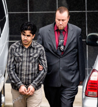Omar Faraj Saeed Al Hardan, left, is escorted by U.S. Marshals from the Bob Casey Federal Courthouse on Friday, Jan. 8, 2016, in Houston. Al Hardan made his initial appearance in federal court in Houston Friday morning after he was indicted Wednesday on three charges related to accusations he tried to provide material support to the Islamic State group.  (AP Photo/Bob Levey)