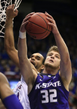 Kansas State forward Dean Wade (32) rebounds against Kansas forward Perry Ellis, back, during the first half of an NCAA college basketball game in Lawrence, Kan., Wednesday, Feb. 3, 2016. (AP Photo/Orlin Wagner)