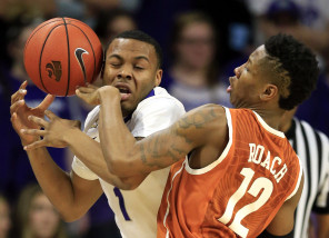 Kansas State guard Carlbe Ervin II (1) is fouled by Texas guard Kerwin Roach Jr. (12) during the first half of an NCAA college basketball game in Manhattan, Kan., Monday, Feb. 22, 2016. (AP Photo/Orlin Wagner)