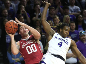 Oklahoma forward Ryan Spangler (00) is fouled by Kansas State forward D.J. Johnson (4) during the first half of an NCAA college basketball game at Bramlage Coliseum in Manhattan, Kan., Saturday, Feb. 6, 2016. (AP Photo/Orlin Wagner)