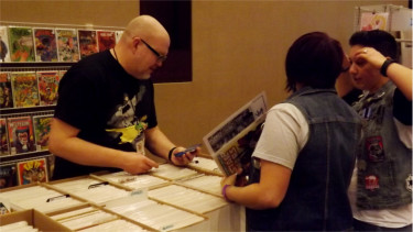 Little Apple Comic Con attendees look through comic book bins during Saturday's first large-scale comic book convention in Manhattan. 