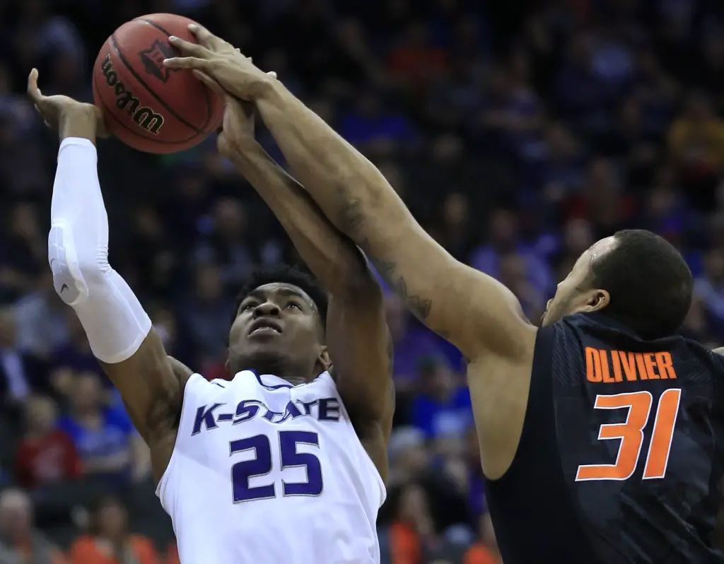 Kansas State forward Wesley Iwundu (25) shoots while covered by Oklahoma State forward Chris Olivier (31) during the first half of an NCAA college basketball game in the first round of the Big 12 conference tournament in Kansas City, Mo., Wednesday, March 9, 2016. (AP Photo/Orlin Wagner)