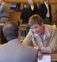 Kansas state Rep. Sydney Carlin, right, a Manhattan Democrat, confers with Dick Carter, a lobbyist representing the city of Manhattan and the area's chamber of commerce, during a break in a House Redistricting Committee meeting, Monday, March 26, 2012, at the Statehouse in Topeka, Kan. They're working to see that Manhattan stays in the 2nd Congressional District of eastern Kansas. (AP Photo/John Hanna).