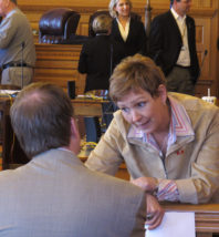 Kansas state Rep. Sydney Carlin, right, a Manhattan Democrat, confers with Dick Carter, a lobbyist representing the city of Manhattan and the area's chamber of commerce, during a break in a House Redistricting Committee meeting, Monday, March 26, 2012, at the Statehouse in Topeka, Kan. They're working to see that Manhattan stays in the 2nd Congressional District of eastern Kansas.  (AP Photo/John Hanna).