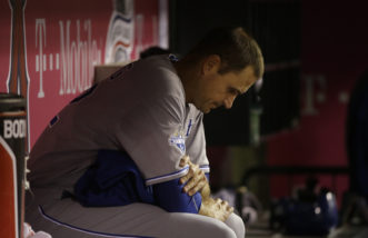 Kansas City Royals starting pitcher Chris Young sits in the dugout during the third inning of a baseball game against the Los Angeles Angels, Wednesday, April 27, 2016, in Anaheim, Calif. (AP Photo/Jae C. Hong)