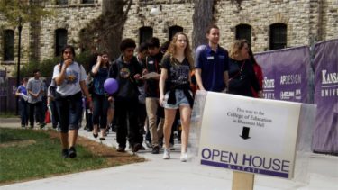 A K-State ambassador leads a group of visitors Saturday afternoon around the campus of KSU in Manhattan during the university's annual Open House. (Staff photos by Brady Bauman)