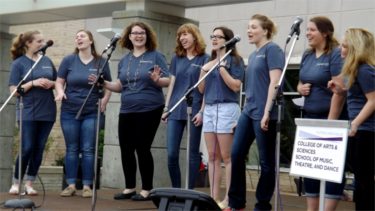 An all-women K-State a cappella group entertain the crowd Saturday afternoon in the student union courtyard during the university's annual Open House.