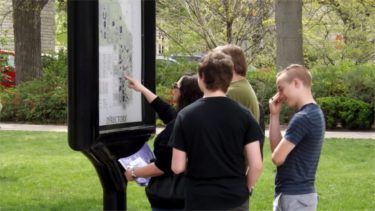 Visitors of K-State consult the campus map Saturday afternoon during the university's annual Open House. 