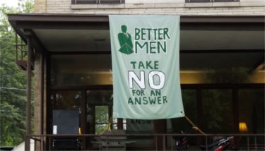 The K-State Delta Sigma Phi - Alpha Upsilon fraternity chapter displays a banner speaking out against sexual assault and rape in front of its house Saturday morning in Manhattan. (Staff photo by Brady Bauman)