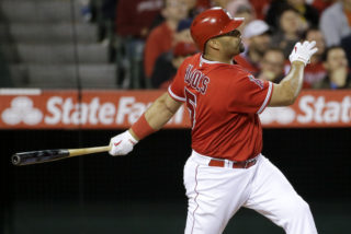 Los Angeles Angels' Albert Pujols watches his home run against the Kansas City Royals during the fifth inning of a baseball game in Anaheim, Calif., Monday, April 25, 2016. (AP Photo/Chris Carlson)