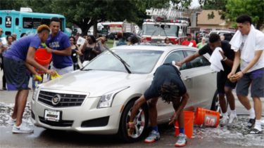 Members of the K-State men's basketball team compete in the car wash contest during Saturday's annual Juneteenth celebration in Manhattan's City Park. (Staff photos by Brady Bauman)