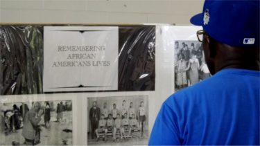 A man looks through a section of historical displays Saturday inside the GTM Family Center at Manhattan's City Park for the the 27th-annual Juneteenth celebration. 