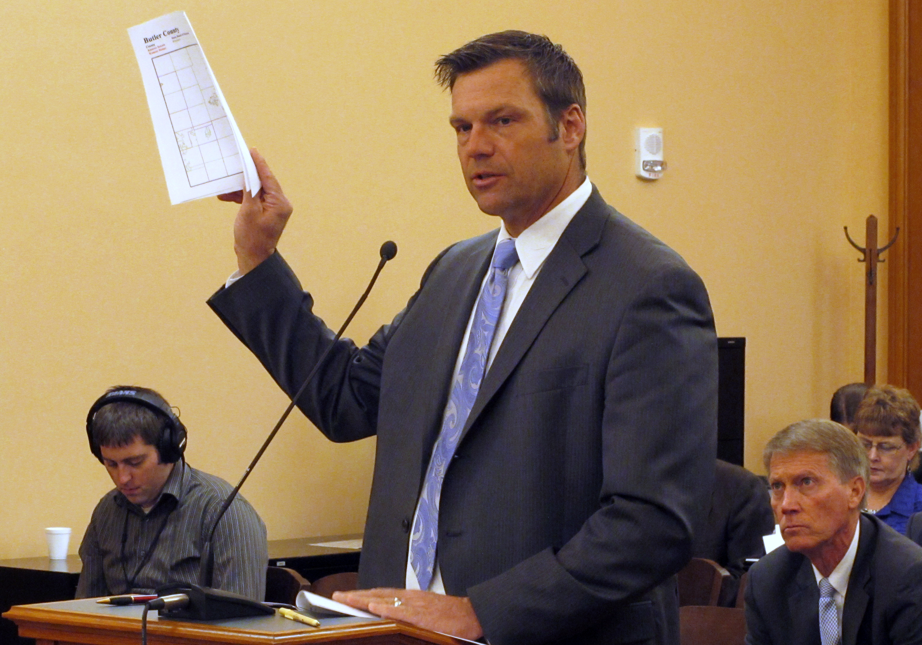Kansas Secretary of State Kris Kobach testifies during a meeting of a legislative study committee on election issues, Friday, Nov. 21, 2014, at the Statehouse in Topeka, Kan. Kobach says he'll revive a proposal to allow his office to prosecute election fraud cases. (AP Photo/John Hanna)