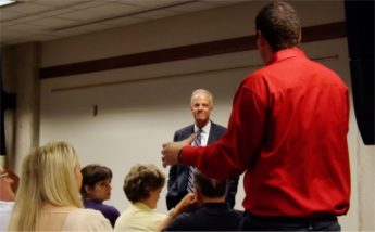 U.S. Sen. Jerry Moran (R - Kan.) takes a question from Jim Hund Friday evening in the Manhattan Public Library. Hund is the president of Vanguard Home Designs in Manhattan.