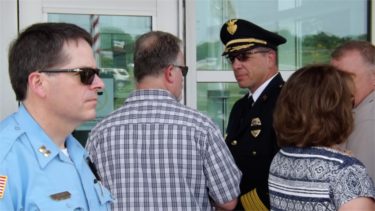 Riley County Police Department Director Brad Schoen, right, speaks to a man who attended Friday afternoon's vigil following Thursday night's police shootings in Dallas. (Staff photo by Brady Bauman)