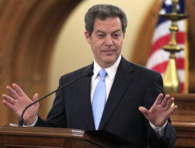 FILE - In this Jan. 12, 2016, file photo, Kansas Gov. Sam Brownback speaks to the legislature in Topeka. The Department of Revenue reported Monday, Aug. 1, that the state collected $425 million in taxes last month, compared with the state's official projection of nearly $438 million. (AP Photo/Orlin Wagner, File)