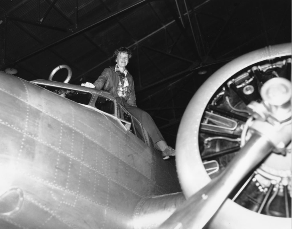 Amelia Earhart is shown climbing out of the cockpit after piloting her plane from Los Angeles to Oakland, Ca., on March 10, 1937. Earhart and her crew will begin their around-the-world journey from Oakland to Howland Island on March 18. (AP Photo)