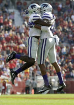 Kansas State defensive back DJ Reed, left, celebrates with teammate Kendall Adams, right, after a defensive stop during the second half of an NCAA college football game against Iowa State, Saturday, Oct. 29, 2016, in Ames, Iowa. Kansas State won the game 31-26. (AP Photo/Charlie Neibergall)