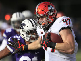 Oklahoma State tight end Blake Jarwin (47) fends off Kansas State defensive back Kendall Adams (21) to score a touchdown during the first half of an NCAA college football game in Manhattan, Kan., Saturday, Nov. 5, 2016. (AP Photo/Orlin Wagner)