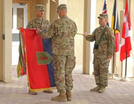 Maj. Gen. Joseph Martin, 1st Infantry Division and Fort Riley commanding general, and the Command Sgt. Maj. Curt Cornelison, the division's senior noncommissioned officer, uncase the "Big Red One" colors during the Transfer of Authority ceremony Nov. 17 in Baghdad, Iraq. This is the second tour for the 1st Inf. Div. in support of Operation Inherent Resolve. (Spc. Anna Pongo, 1st Inf. Div. Public Affairs)