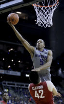 Kansas State's Barry Brown (5) gets past Washington State's Conor Clifford (42) to shoot during the first half of an NCAA college basketball game Saturday, Dec. 10, 2016, in Kansas City, Mo. (AP Photo/Charlie Riedel)