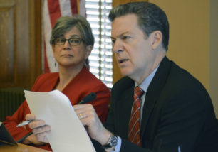 Kansas Gov. Sam Brownback makes a point during a meeting with legislative leaders in which they approved a total of $478,000 in additional funding for five school districts, Tuesday, May 5, 2015, at the Statehouse in Topeka, Kan. To his left is Senate President Susan Wagle, a Wichita Republican. (AP Photo/Nicholas Clayton)