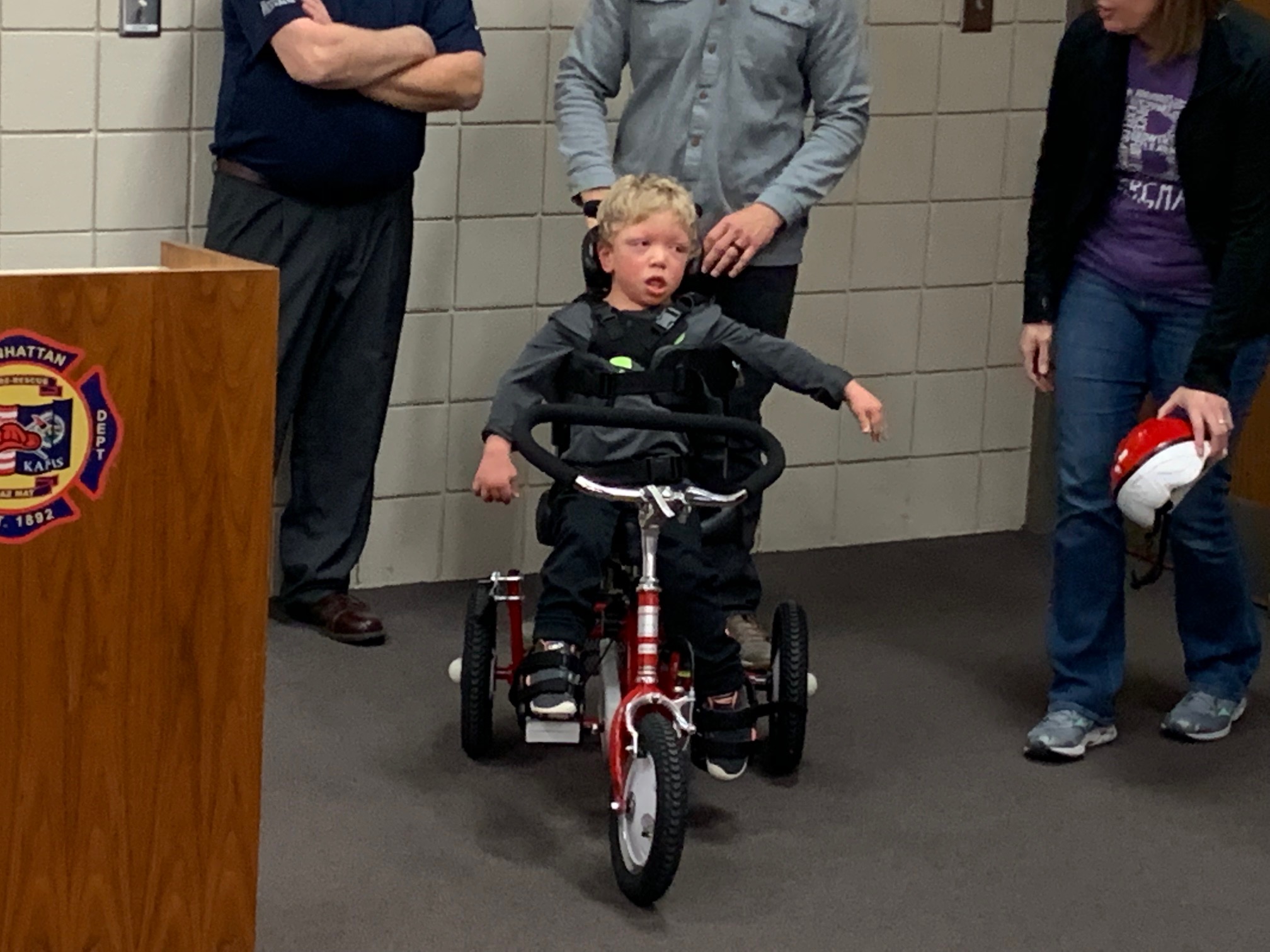 Two children with physical disabilities receive custommade tricycles